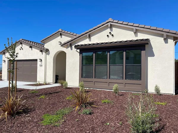 a front view of a house with a yard
