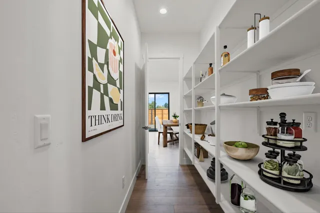 a kitchen with stainless steel appliances lots of counter top space and wooden floor