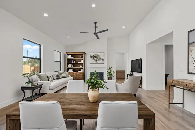 a living room with furniture a flat screen tv and a potted plant