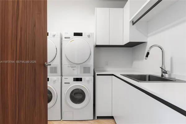a close view of a sink and cabinets in the kitchen