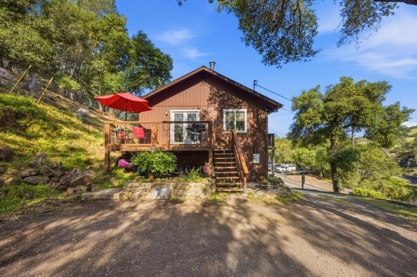 2353 Stagecoach Canyon Road Pope Valley, CA 94567 - Photo 1 of 46 a view of a house with a yard and potted plants