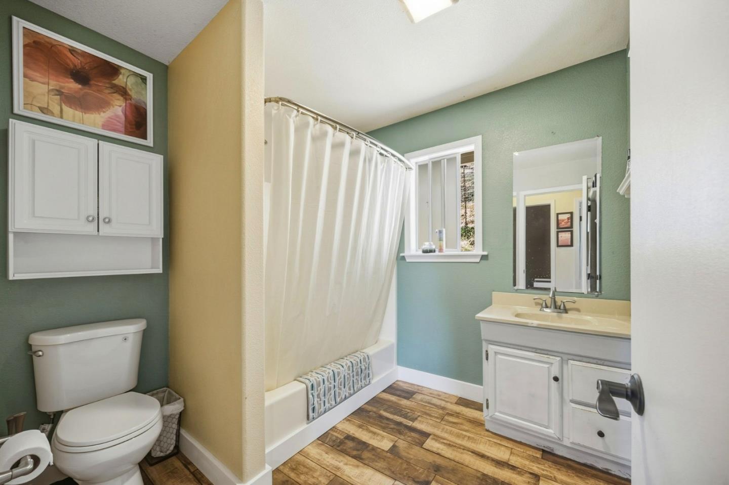 2353 Stagecoach Canyon Road Pope Valley, CA 94567 - Photo 21 of 46 a bathroom with a toilet a sink and a mirror