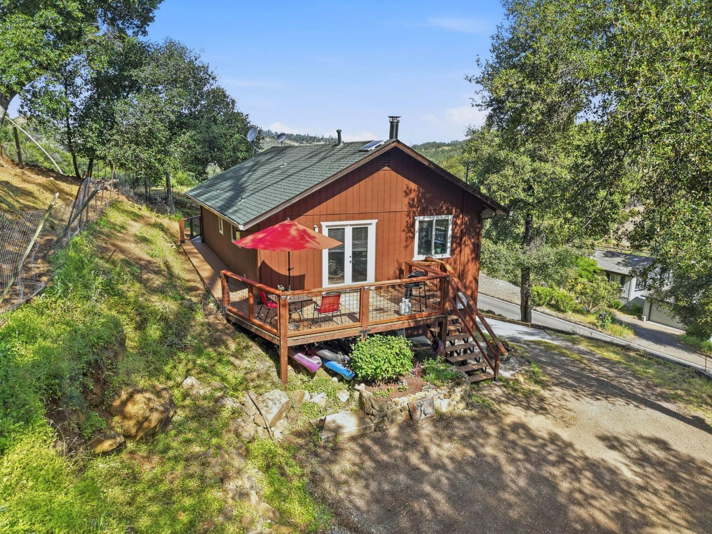 2353 Stagecoach Canyon Road Pope Valley, CA 94567 - Photo 33 of 46 a view of a wooden house with a small yard and large trees