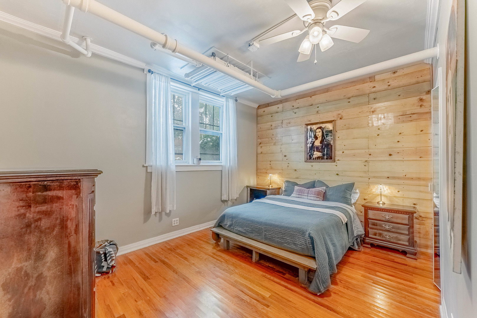 6430 North Glenwood Avenue, Unit G4 Chicago, IL 60626 - Photo 12 of 33 a bedroom with a bed and a chandelier