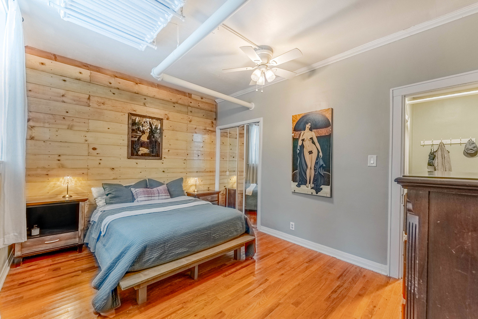 6430 North Glenwood Avenue, Unit G4 Chicago, IL 60626 - Photo 14 of 33 a bedroom with a bed and a chandelier