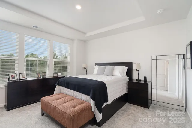 a spacious bedroom with a bed and a window