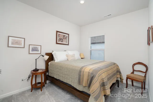 a bedroom with a bed and a chair