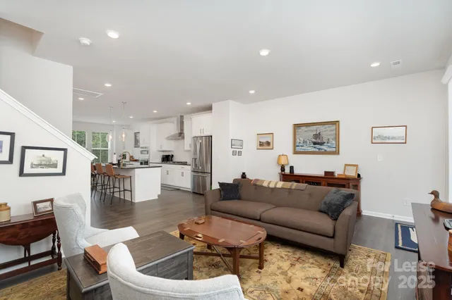 a living room with furniture kitchen view and a dining table