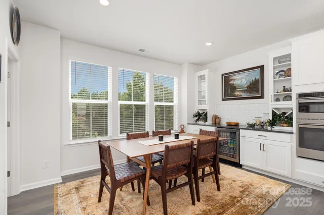 a dining room with a wooden table and chairs