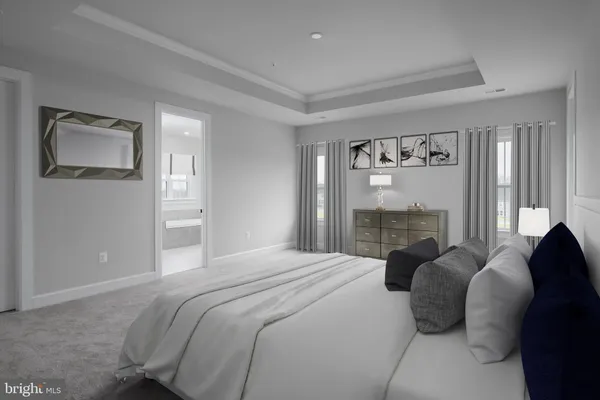 a bedroom with a bed and a large mirror