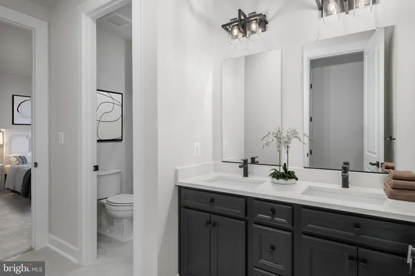 a bathroom with a double vanity sink toilet and shower