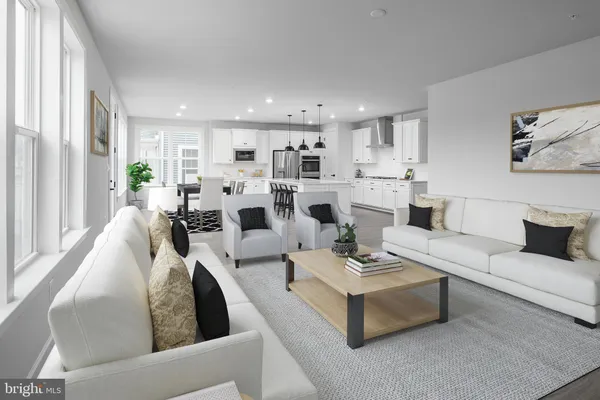 a living room with fireplace furniture and a large window