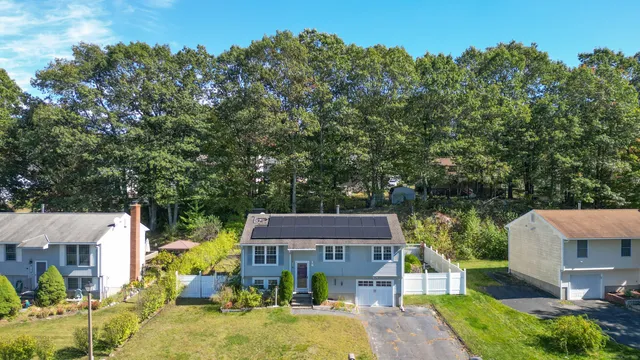 an aerial view of a house with swimming pool garden and patio