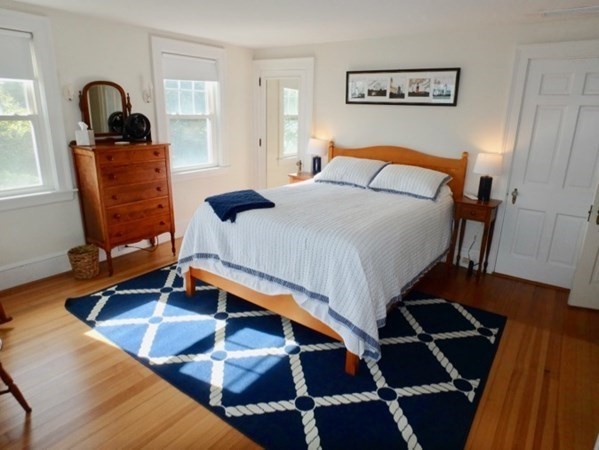 17 Edgartown Bay Road Edgartown, MA 02539 - Photo 11 of 31 a bedroom with a bed and wooden floor