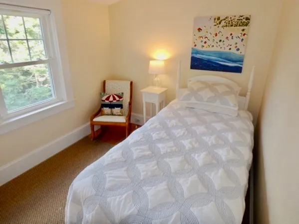 a bed room with a bed and a window