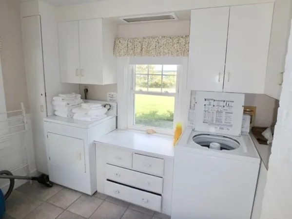 a view of cabinets a washer and dryer