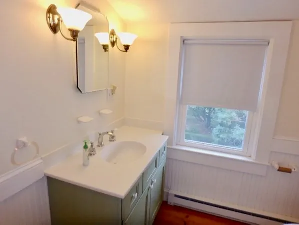 a bathroom with a sink vanity and a mirror