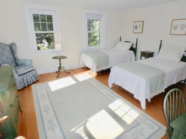 a bedroom with two beds and a window