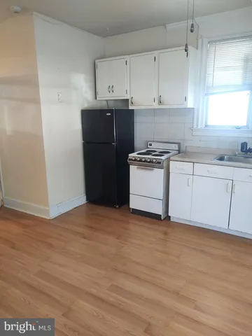 a kitchen with a cabinets and wooden floor