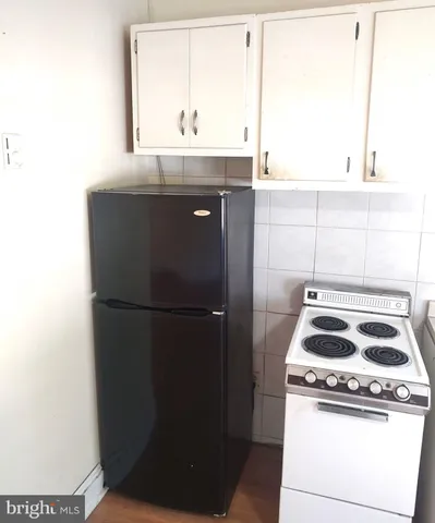 a kitchen with a stove a refrigerator and a sink