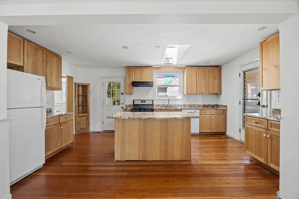 7 Grove Street Wareham, MA 02558 - Photo 7 of 41 a kitchen with a refrigerator cabinets and wooden floor