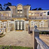 a view of a large building with a bench in front of building