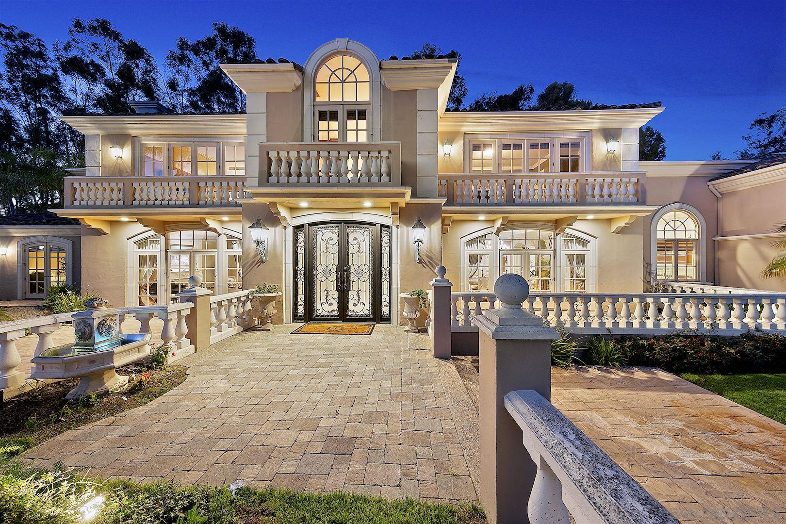 a view of a large building with a bench in front of building