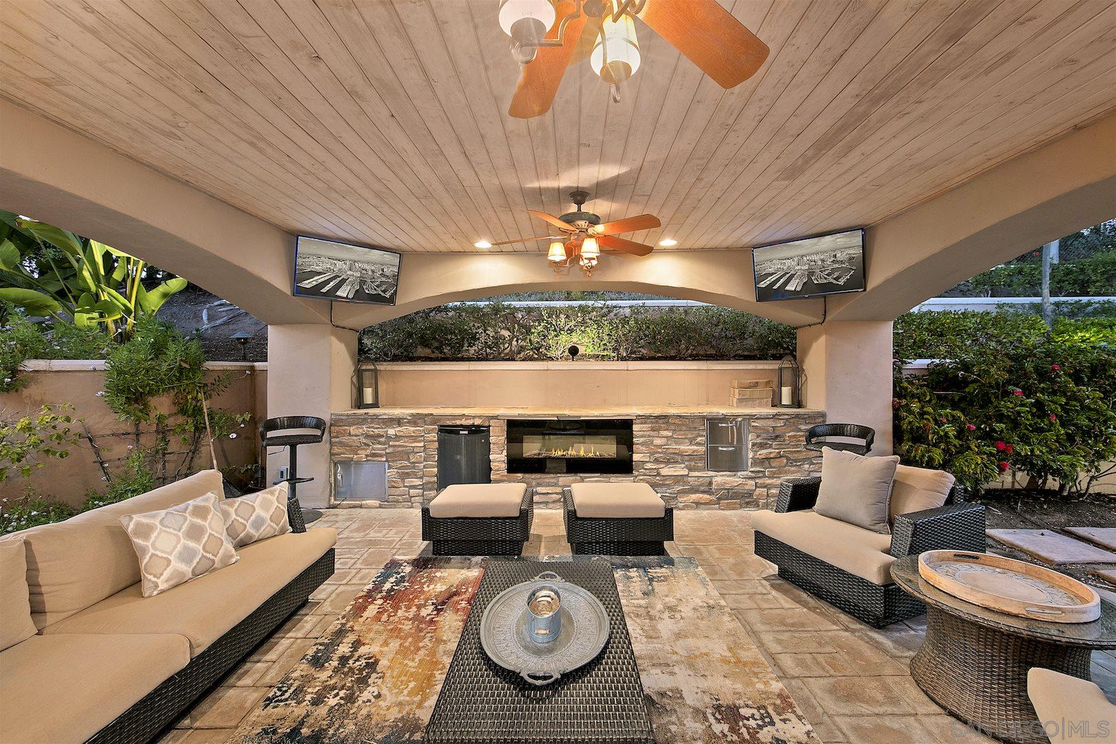 7583 St Andrews Road Rancho Santa Fe, CA 92067 - Photo 18 of 29 a living room with furniture a rug and a fireplace