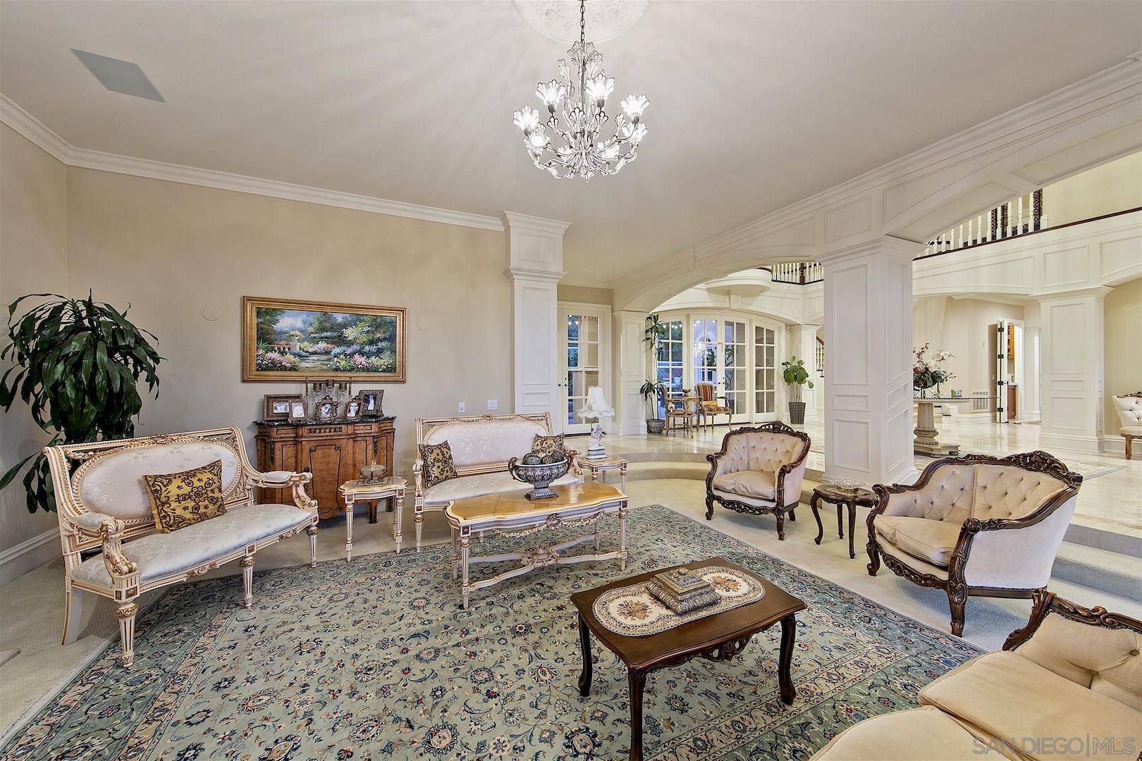 7583 St Andrews Road Rancho Santa Fe, CA 92067 - Photo 4 of 29 a living room with furniture and a chandelier