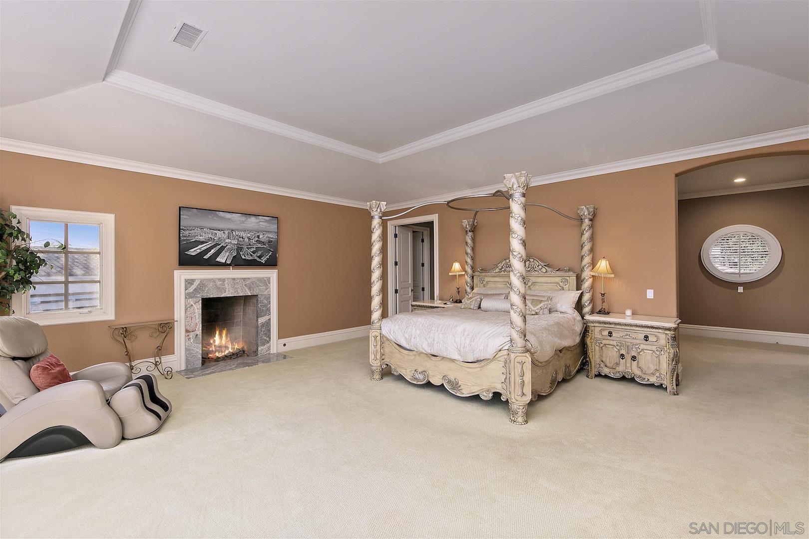 7583 St Andrews Road Rancho Santa Fe, CA 92067 - Photo 6 of 29 a spacious bedroom with a bed and a fireplace