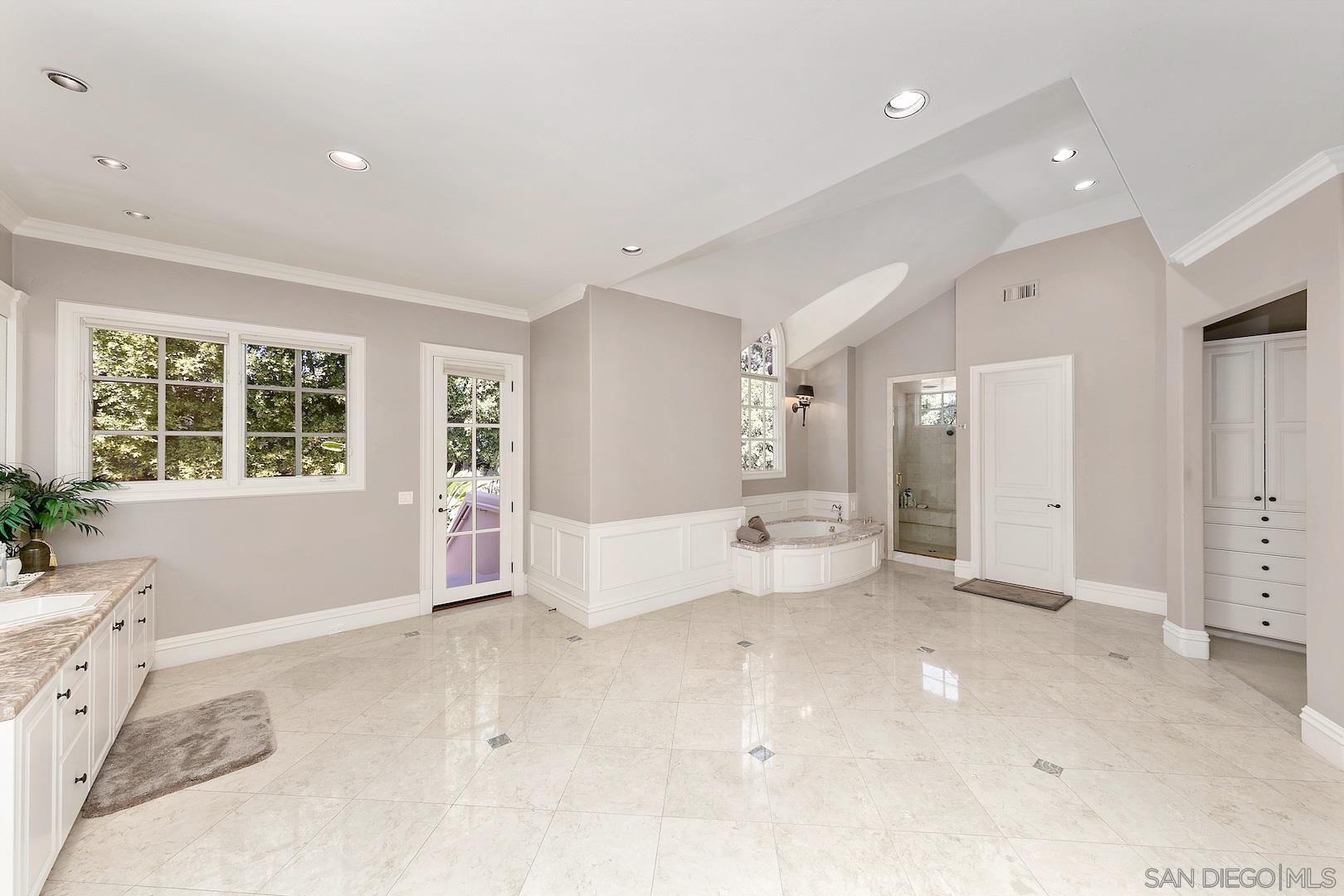 7583 St Andrews Road Rancho Santa Fe, CA 92067 - Photo 7 of 29 a spacious bedroom with a large bed and a window