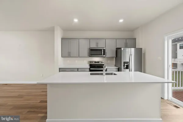a kitchen with stainless steel appliances a refrigerator and a stove