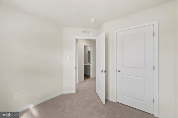 a view of a hallway to rooms