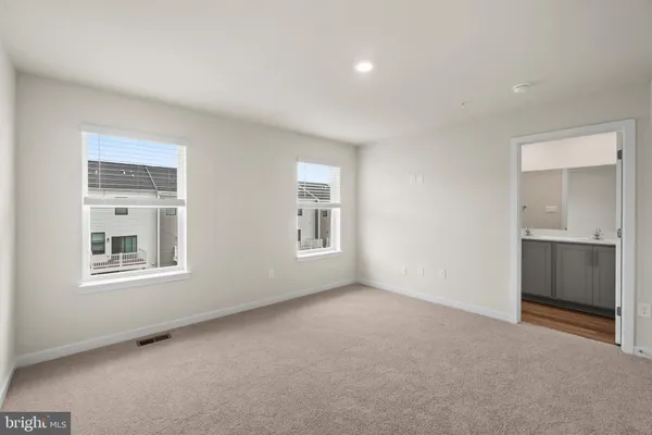 an empty room with a window and a bathroom