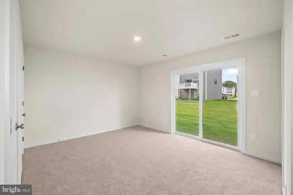 a view of an empty room with glass door