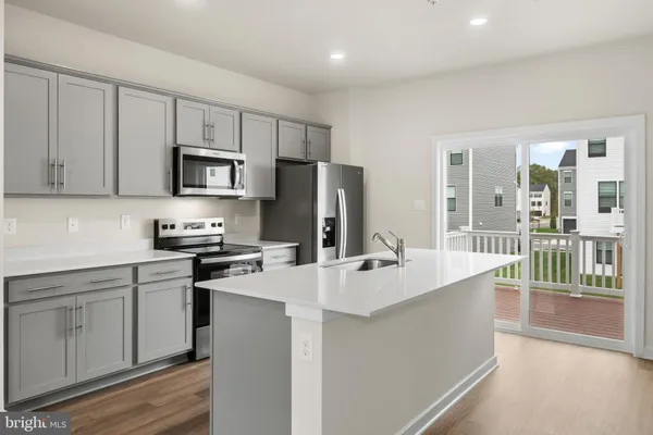 a kitchen with appliances a sink and cabinets