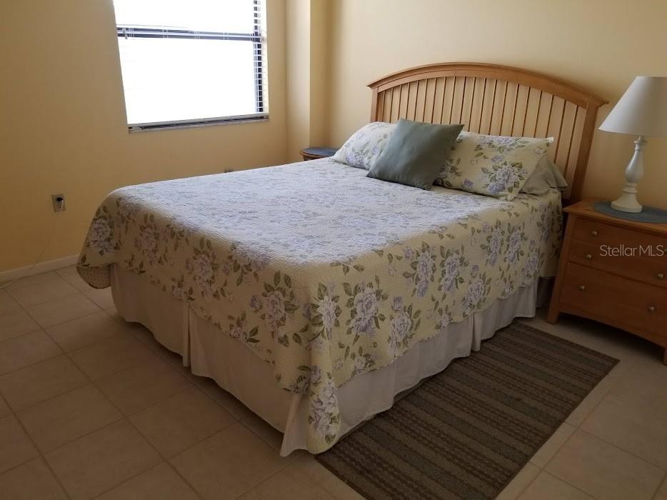 13650 Gulf Boulevard, Unit 304 Madeira Beach, FL 33708 - Photo 53 of 63 a bed sitting in a bedroom next to a window