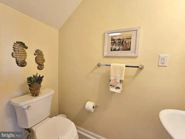 a white toilet sitting next to a bathroom sink