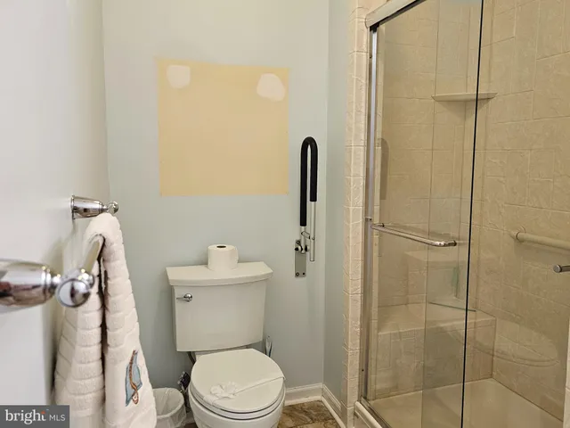 a white toilet sitting next to a bathroom sink