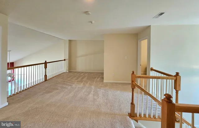 a view of an empty room with stairs