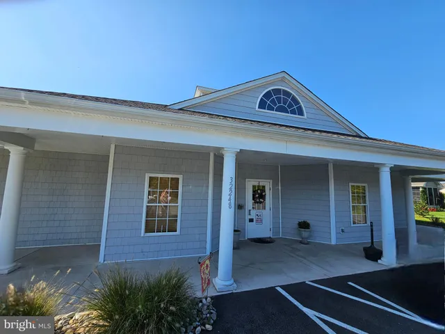 a view of a brick house with potted plants