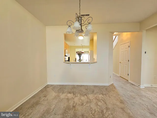 a view of a hallway with a chandelier fan and wooden floor