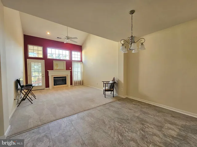 a furnished livingroom with windows and couch