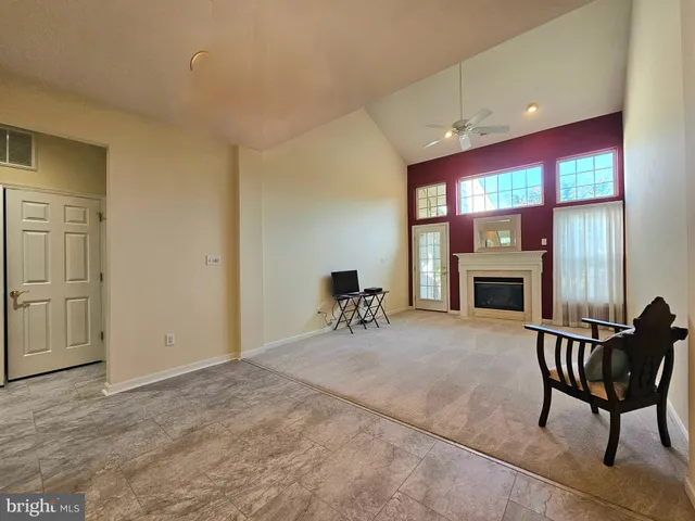 a livingroom with furniture a fireplace and window