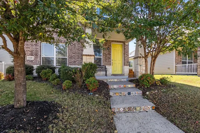 a front view of a house with garden