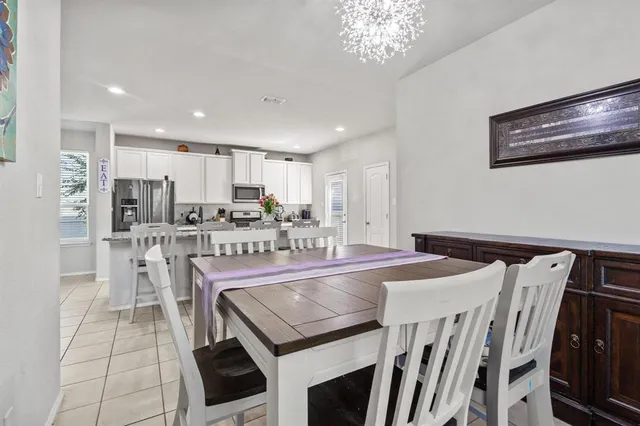 a large kitchen with a table and chairs