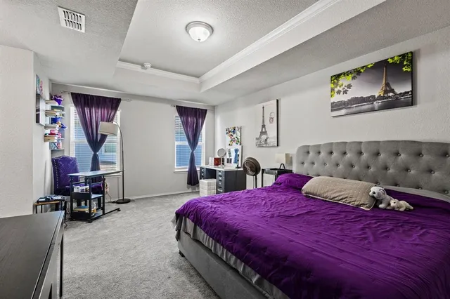 a bedroom with furniture and a flat tv screen