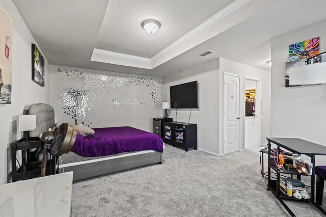 a bedroom with a bed and a couch