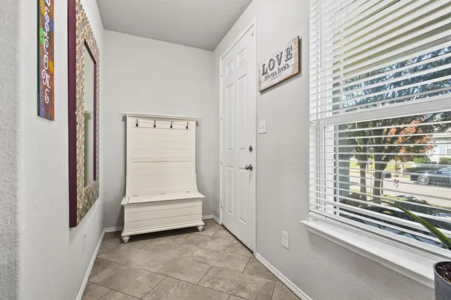 a view of a hallway with entryway and stairs