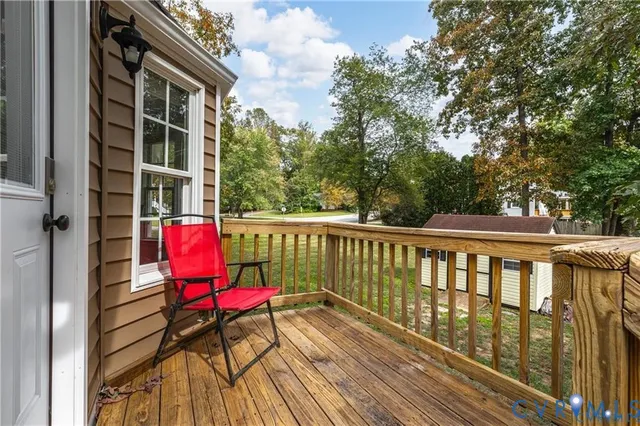 a view of balcony with wooden floor and outdoor seating